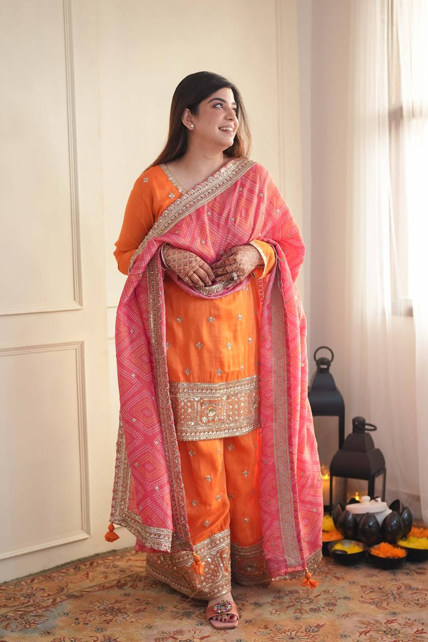 Stylish Orange Ensemble Paired with Pink Dupatta