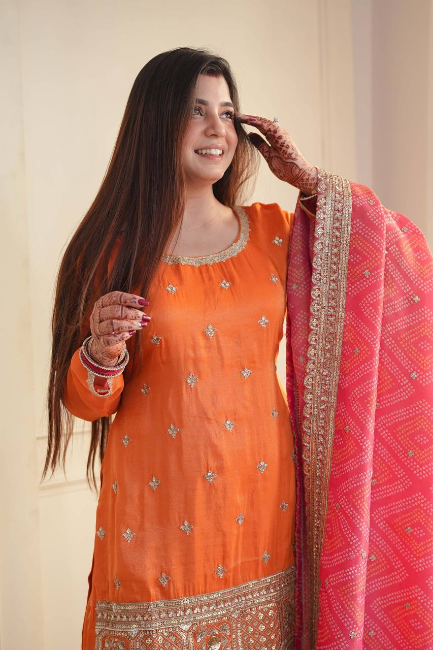 Stylish Orange Ensemble Paired with Pink Dupatta