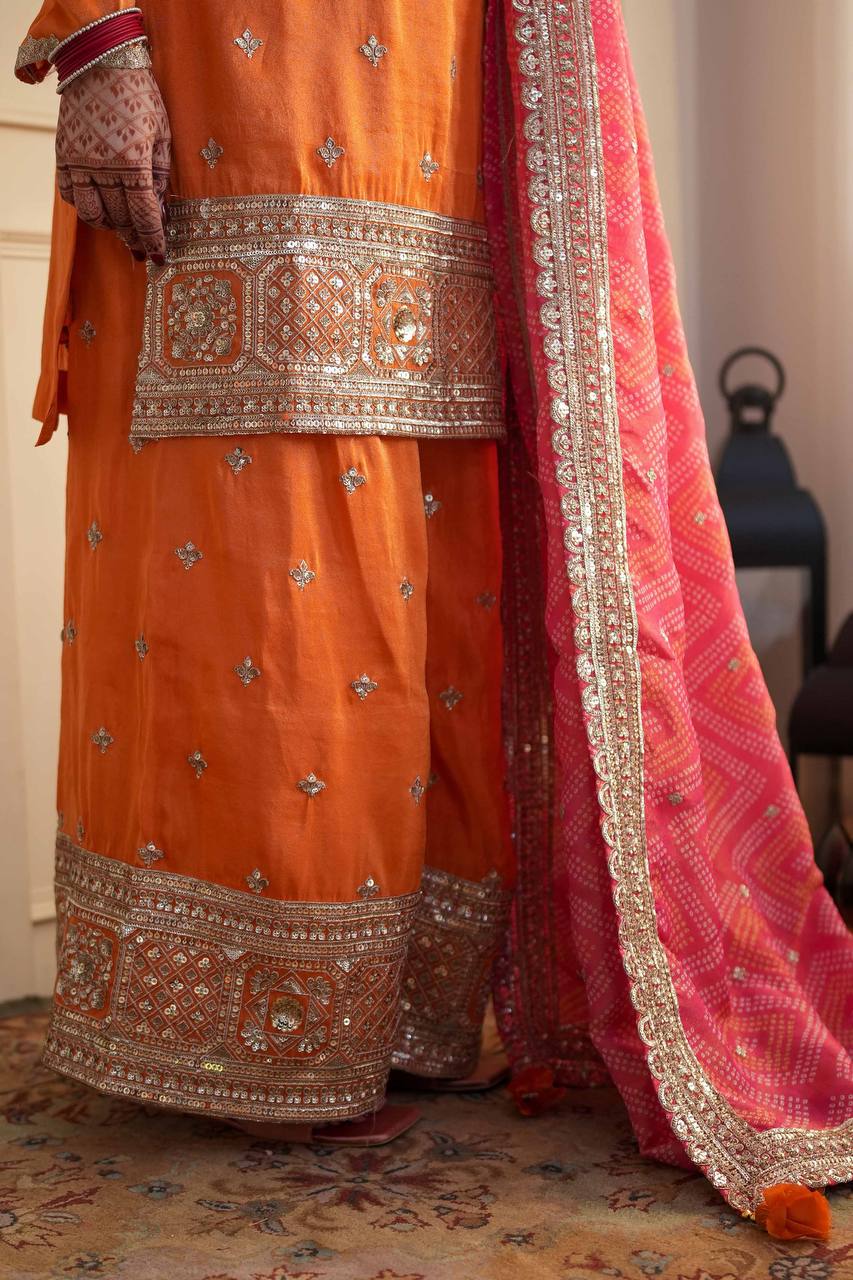 Stylish Orange Ensemble Paired with Pink Dupatta